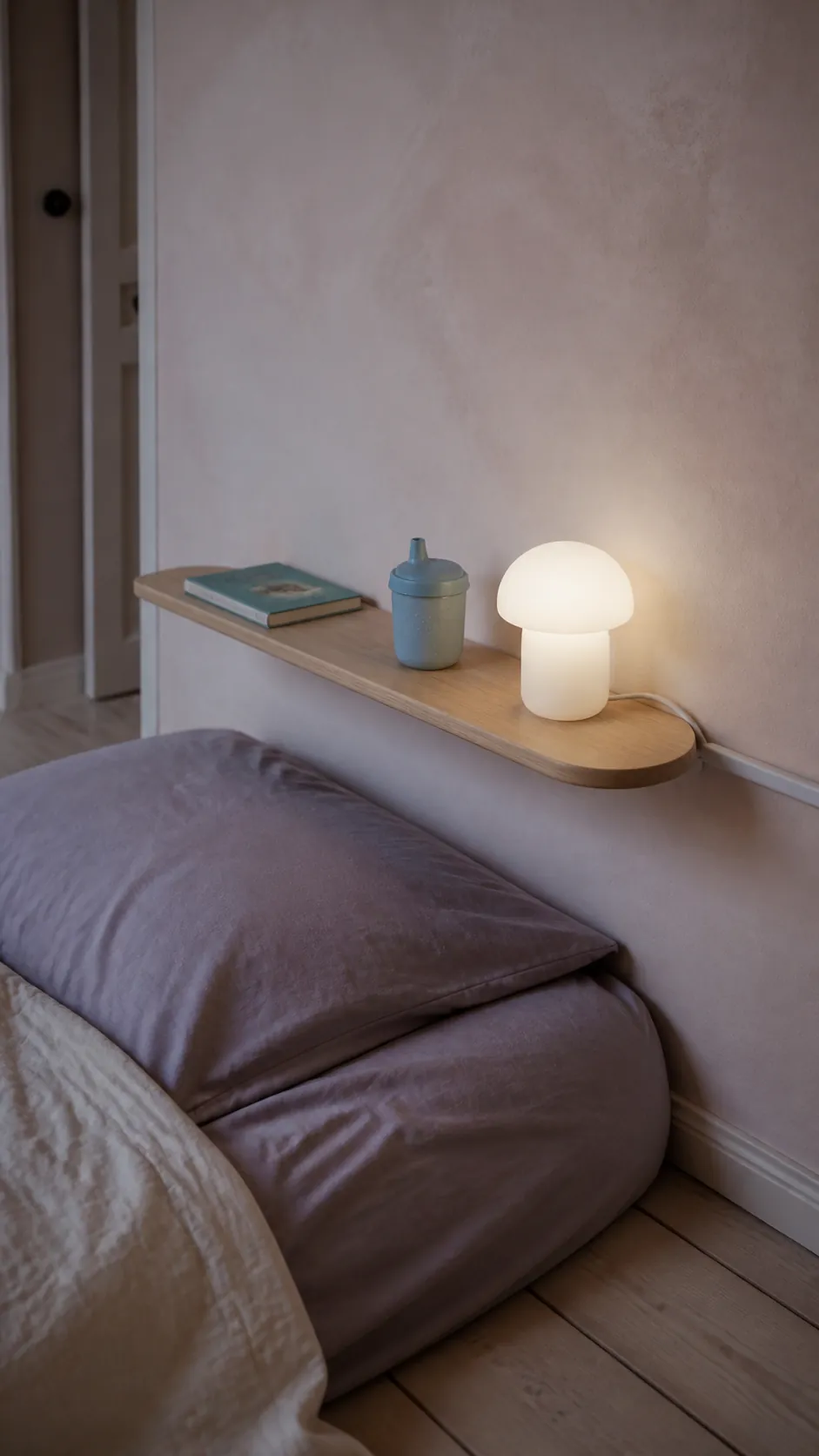 Narrow bedside ledge in a tiny toddler room