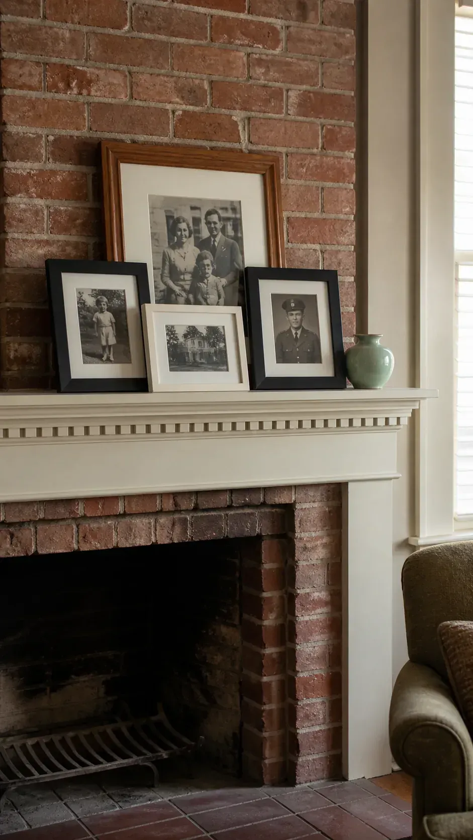 Layered family picture frames arranged on a fireplace mantel