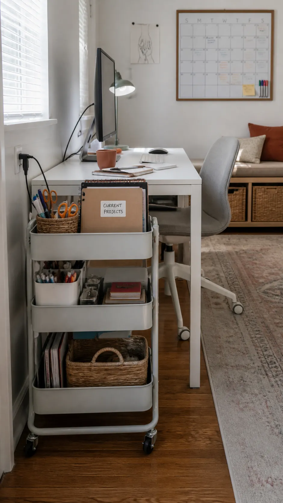 Small desk beside a slim rolling storage cart