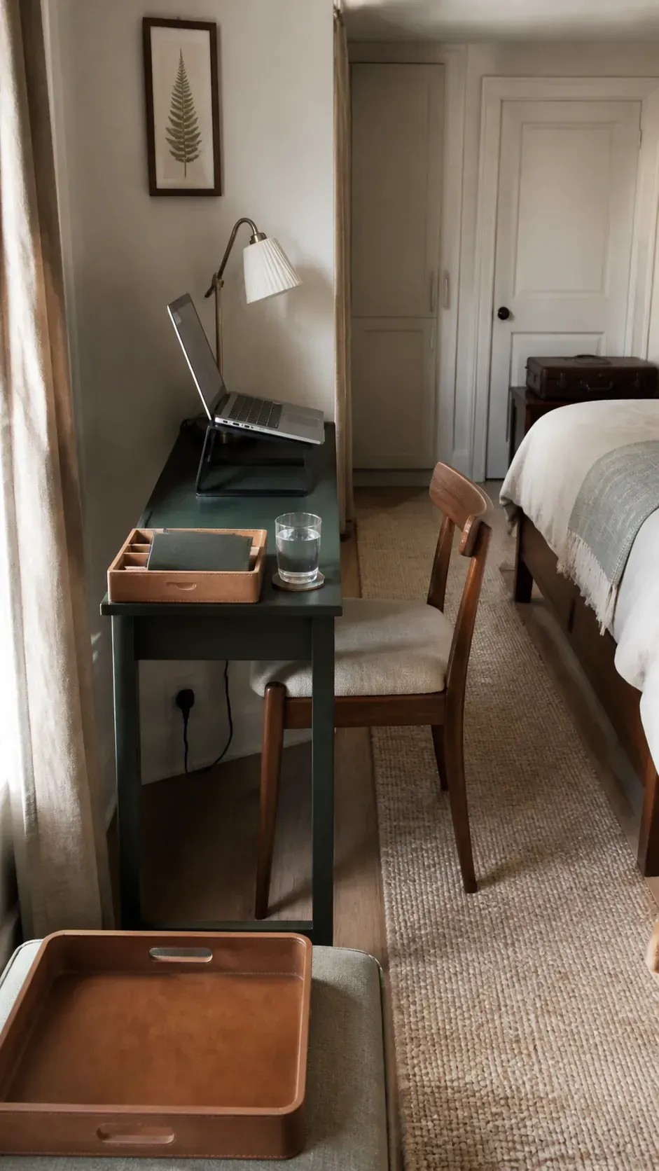 Narrow console used as a practical bedroom workspace