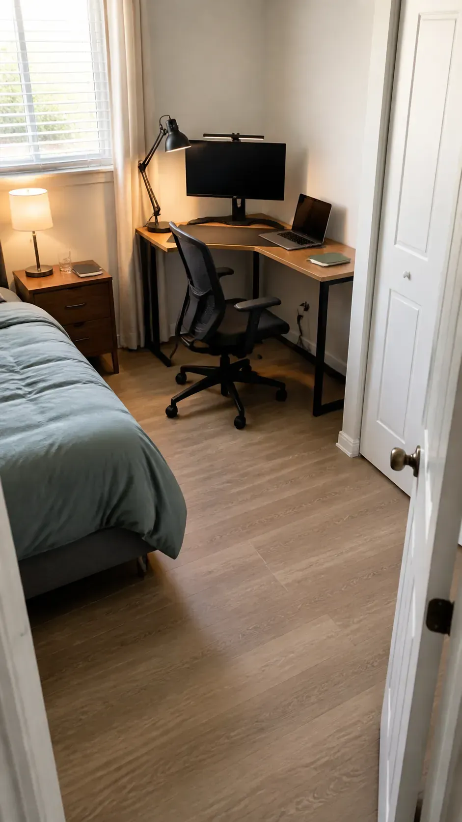 Corner desk preserving the main walkway in a small bedroom