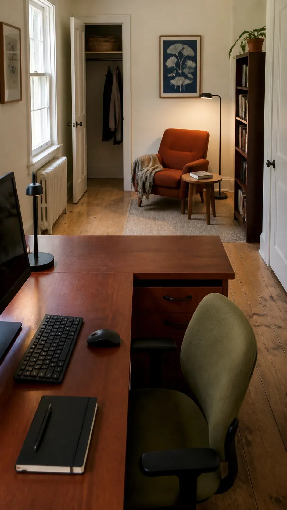 L shaped home office with a reading chair beyond the return