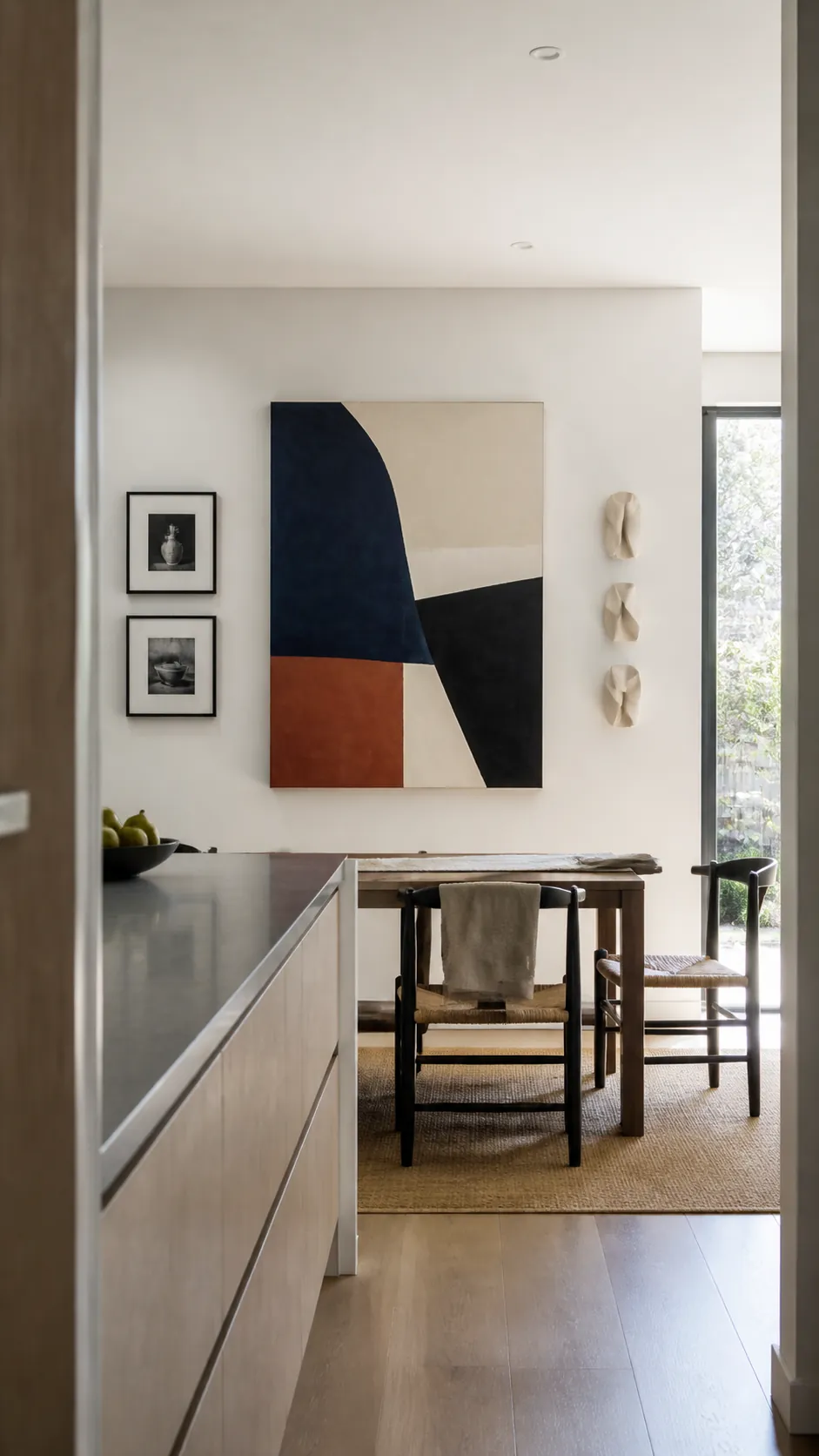 Curated kitchen wall art with abstract painting prints and sculpture