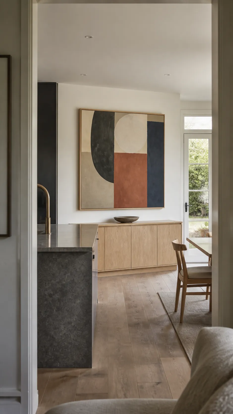 Large geometric abstract painting on a modern kitchen dining wall
