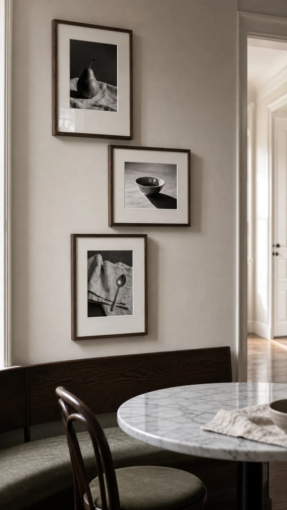 Black and white still life photographs on a kitchen wall