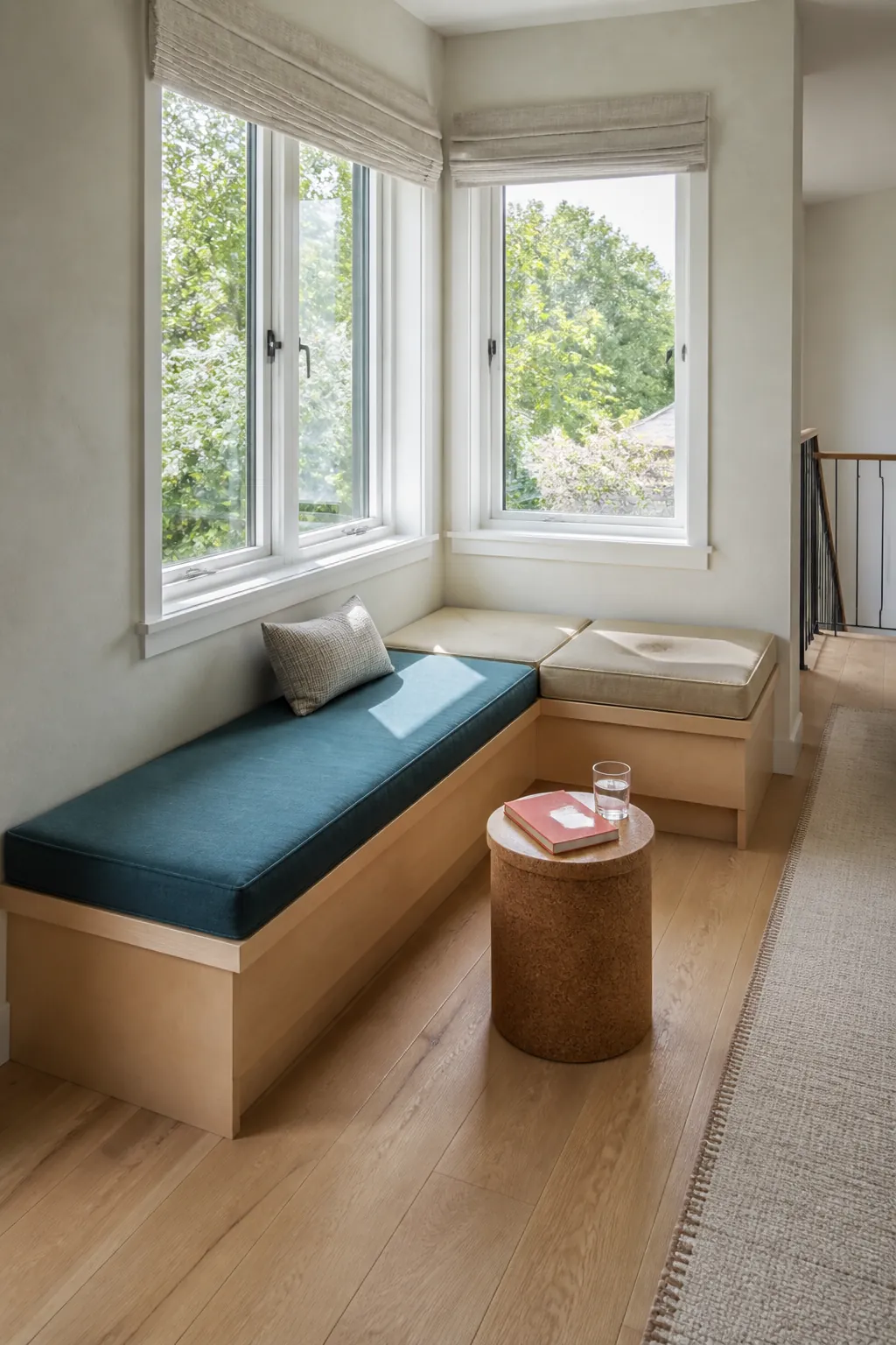 Corner window nook connecting two windows with tailored seat cushions