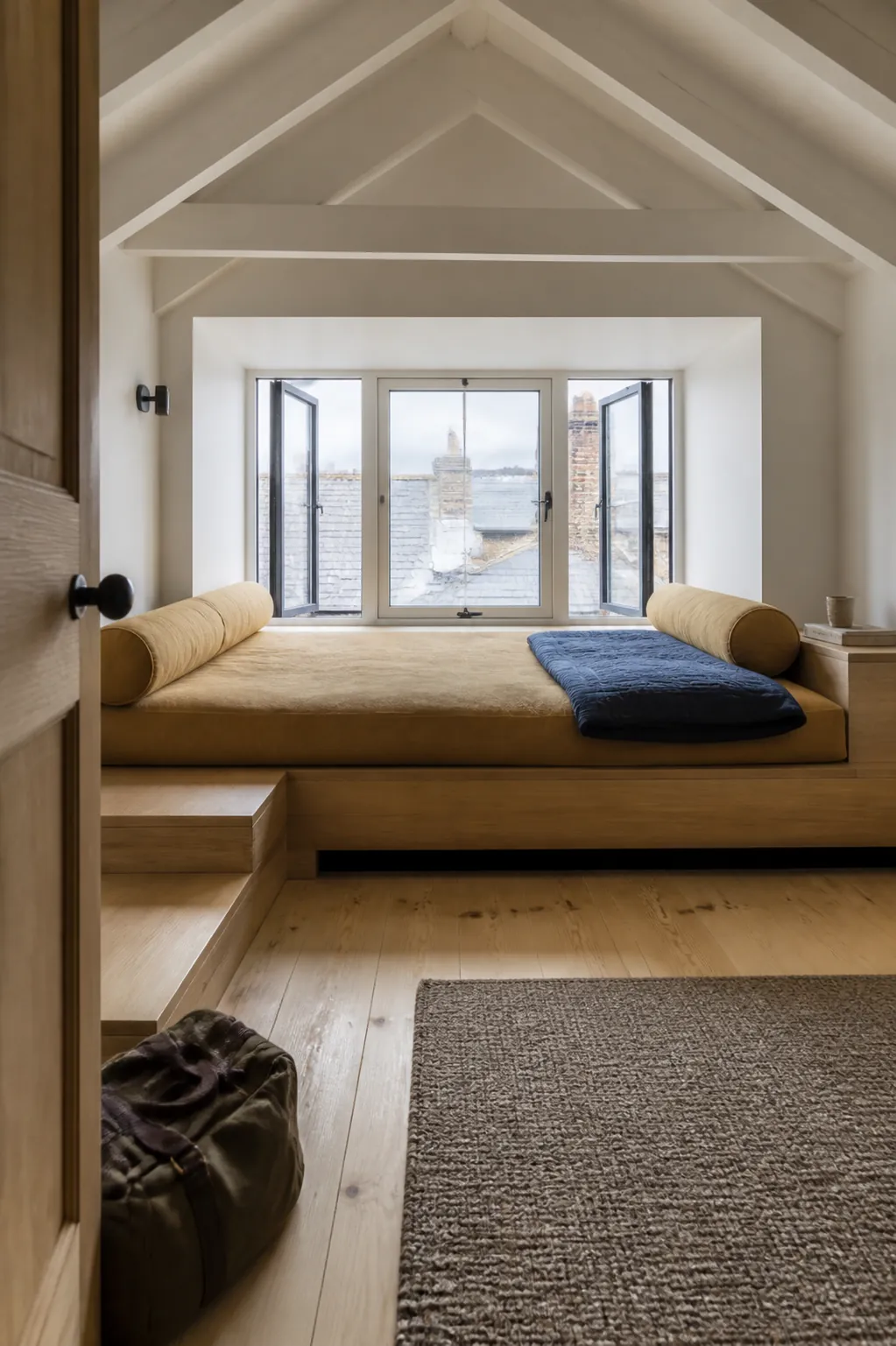 Wide daybed style window platform with a substantial cushion and bolsters
