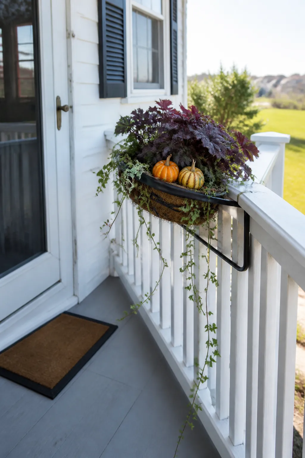 Compact autumn basket secured to the outside of a porch rail