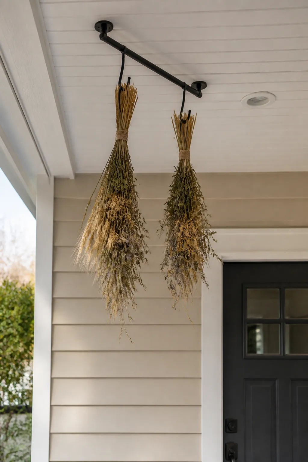 Sparse dried wheat bundles hanging safely above a small porch