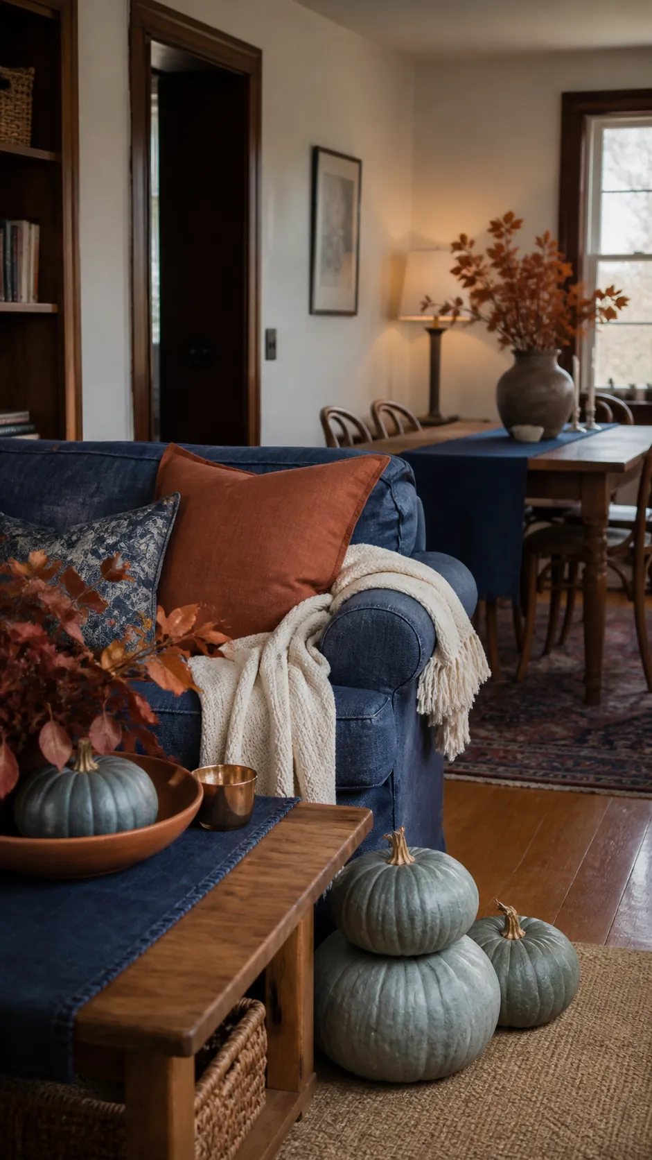Layered blue and orange fall decor in a welcoming lived in home