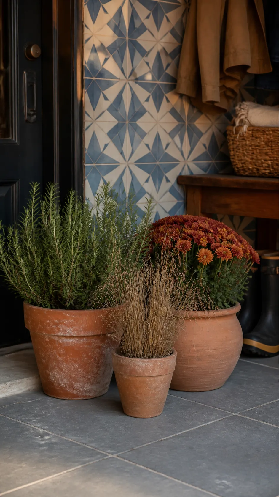Terracotta pots and fall plants against Aegean blue tile