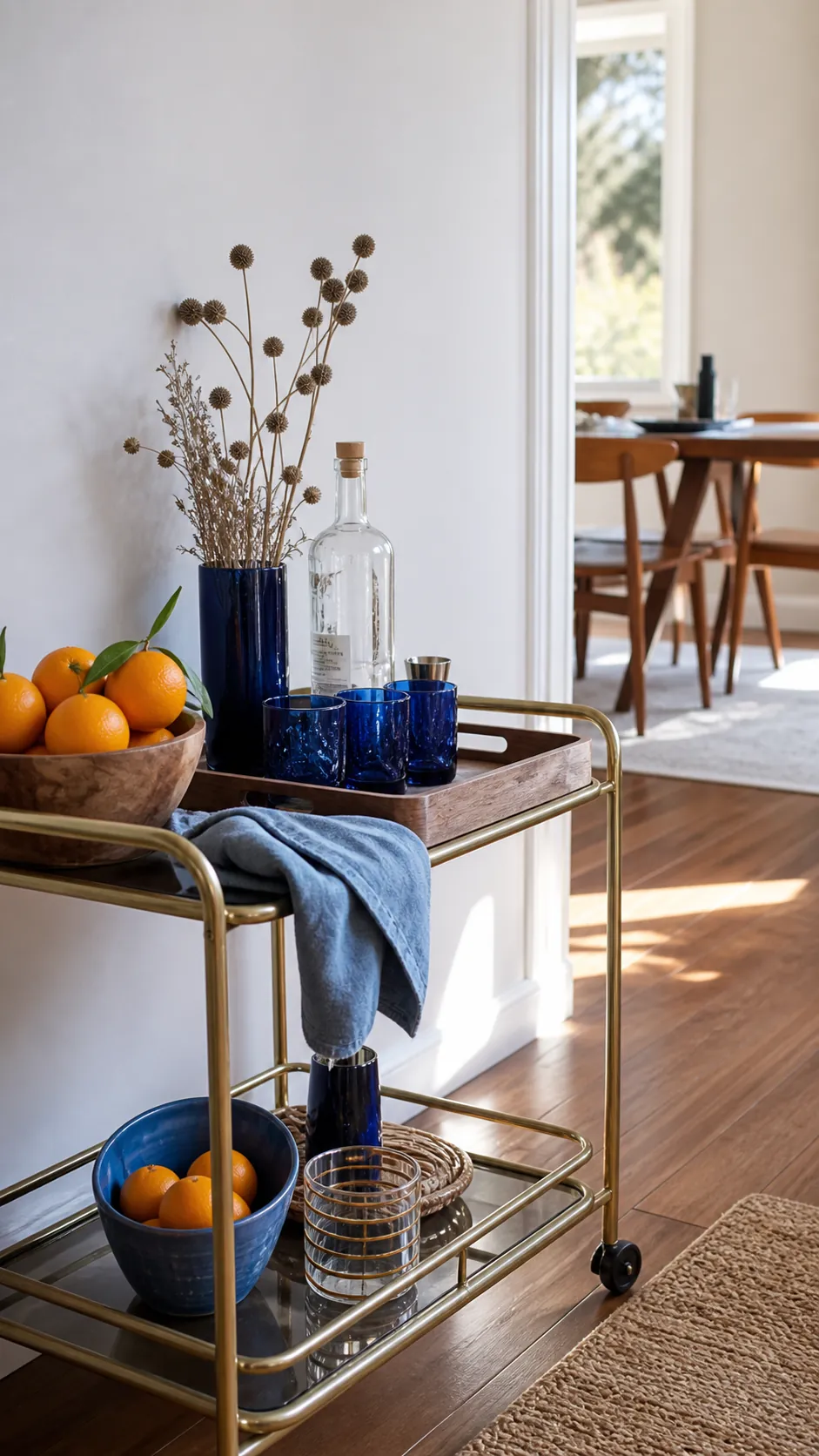 Sapphire blue bar cart styling with citrus and dried stems