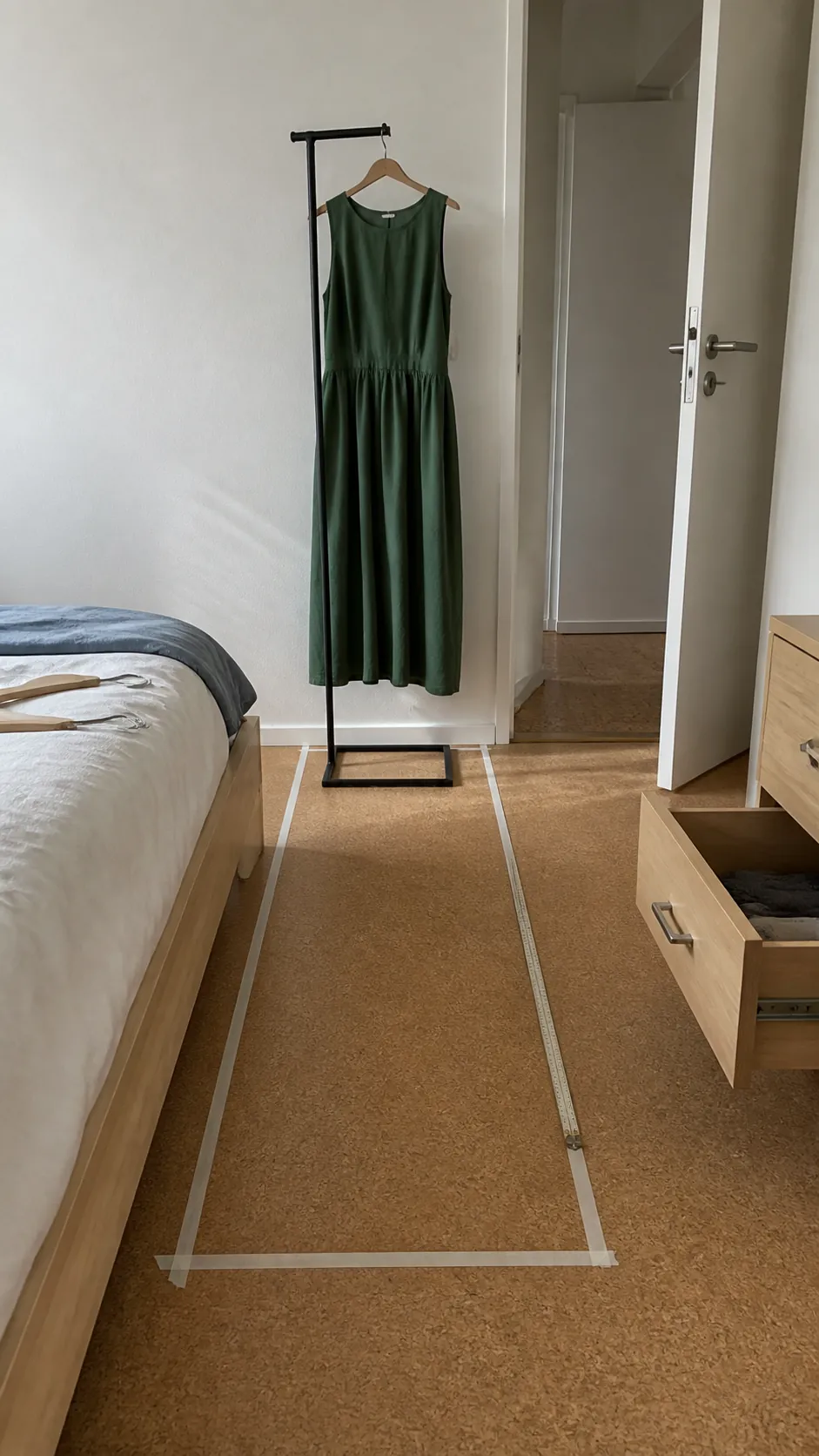 Measured clothing zone beside a clear bedroom walking path