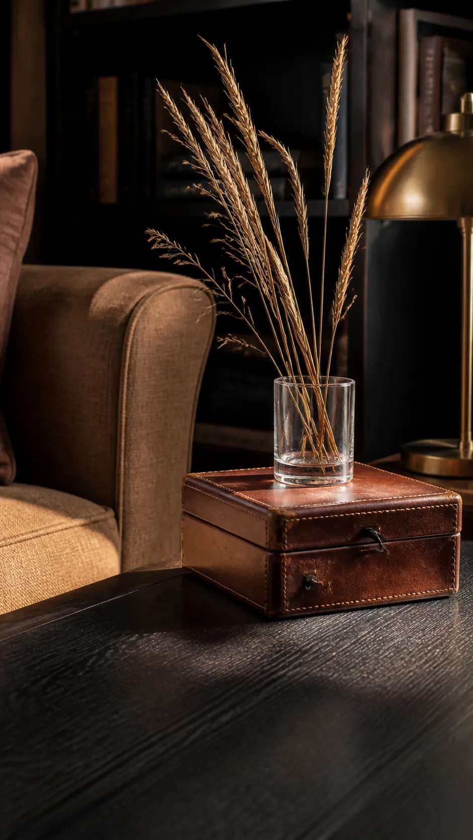 Worn leather box and a vase of golden autumn grasses
