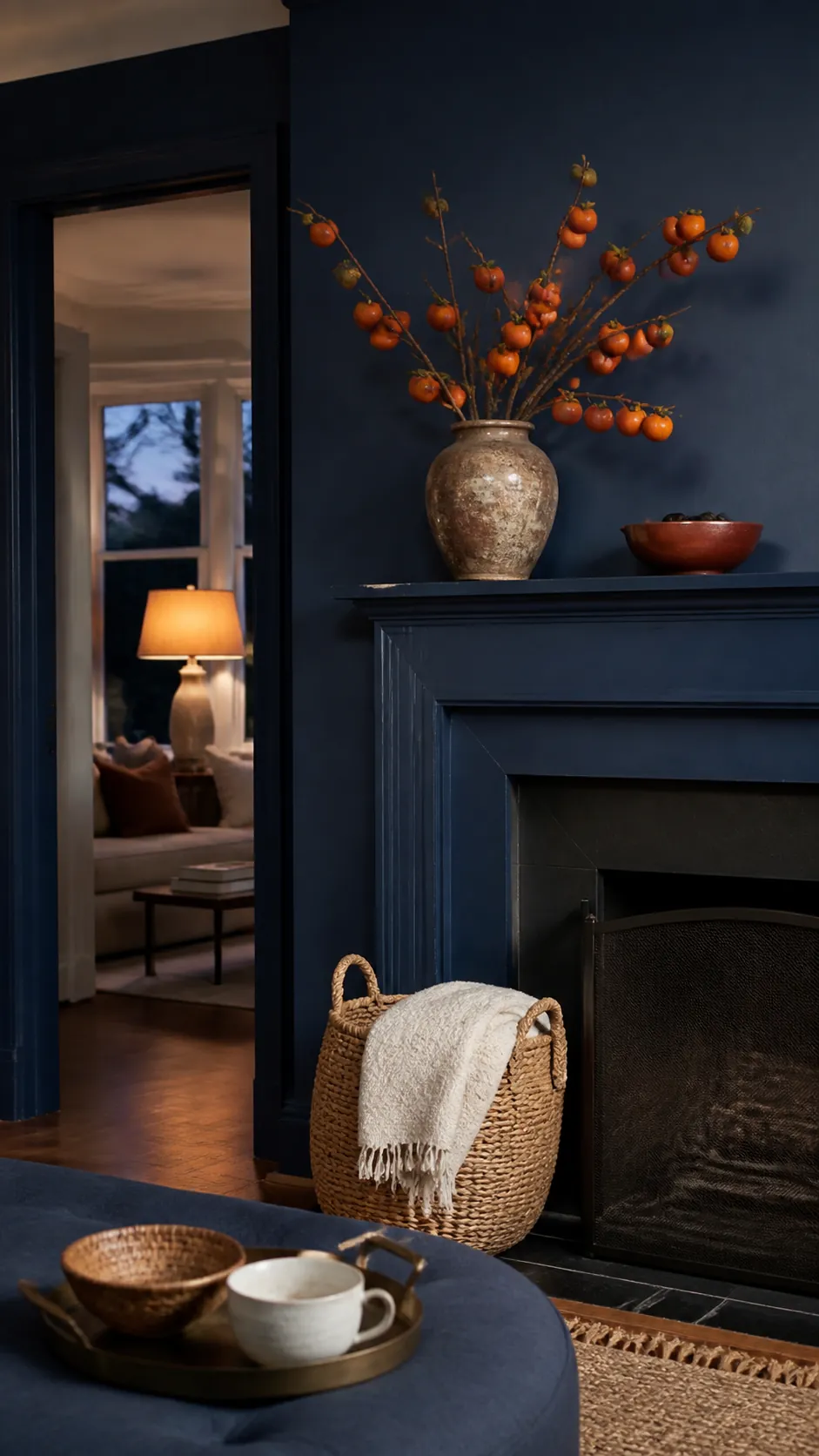 Navy Mantel With Persimmon Branches arranged as navy blue and orange fall decor