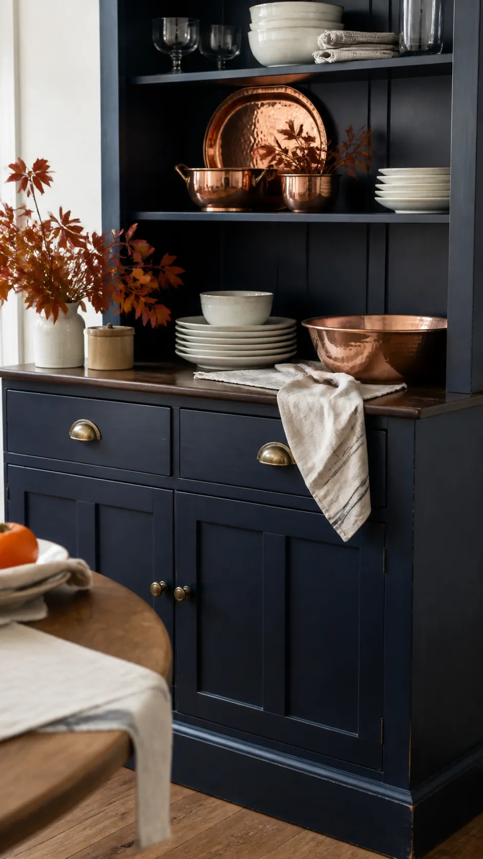 Navy Dining Hutch With Copper Serveware arranged as navy blue and orange fall decor