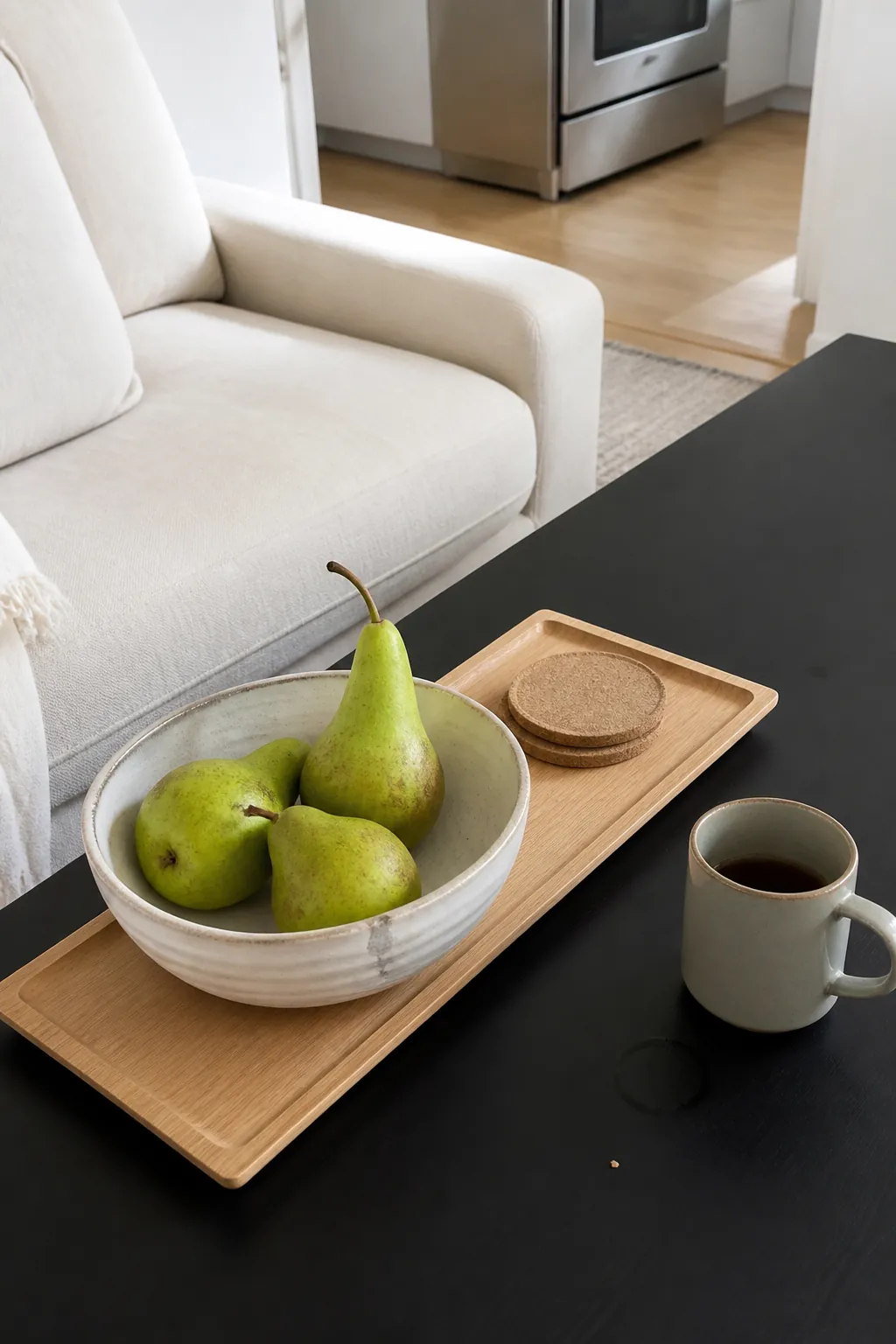 Green pears in a white stone dish on a maple tray