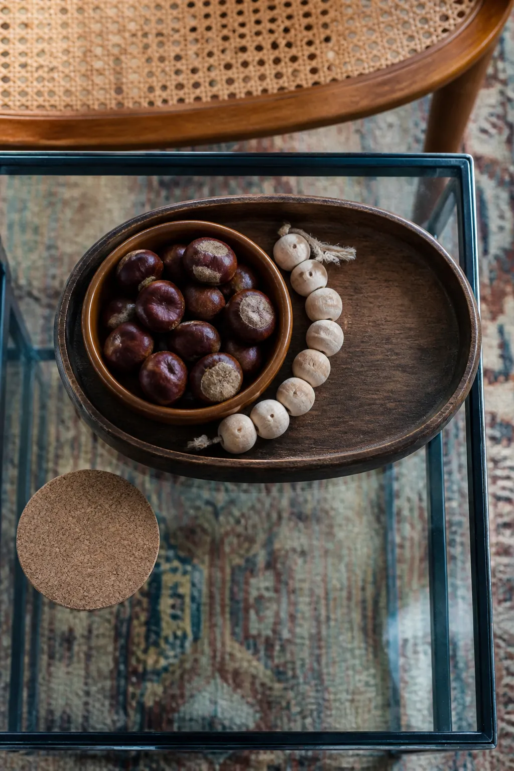 Chestnuts and unfinished wood beads in a black tray