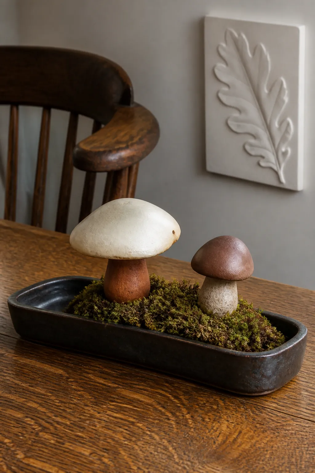 Ceramic mushrooms and moss arranged inside a tray