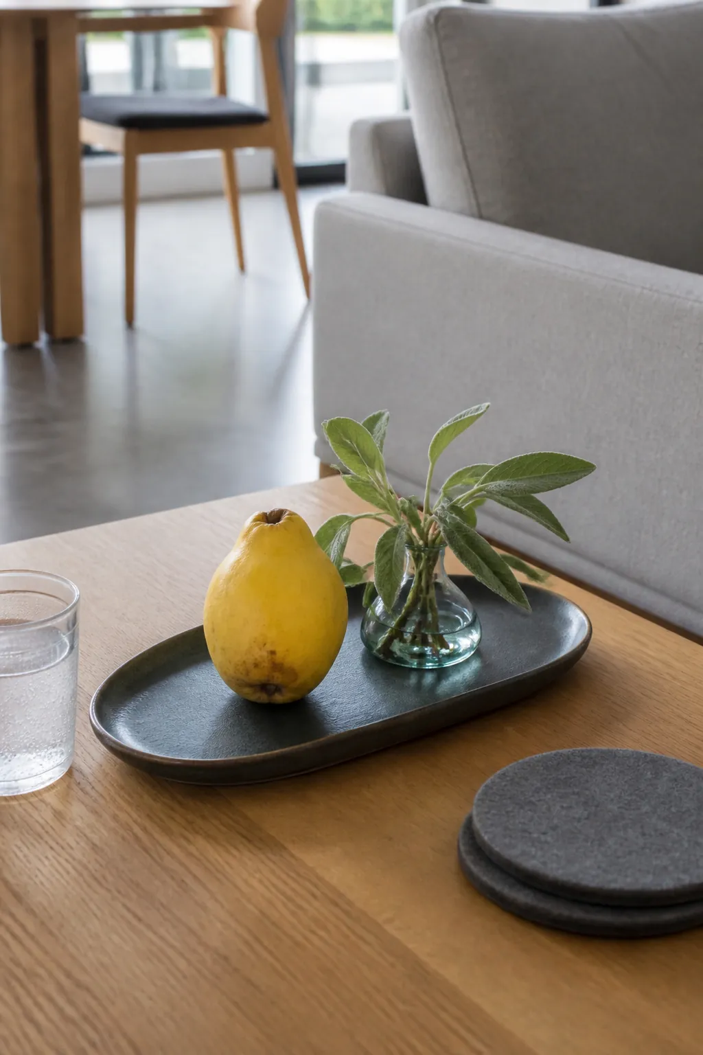 Quince and sage stoneware vase on a black tray