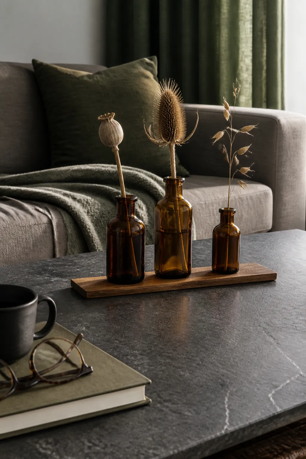 Three brown bottles with simple seed stems for fall table styling
