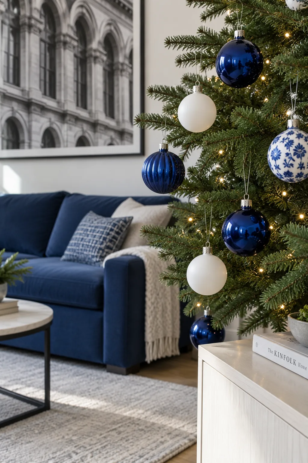 Cobalt and White Christmas tree ornaments beside a navy sofa