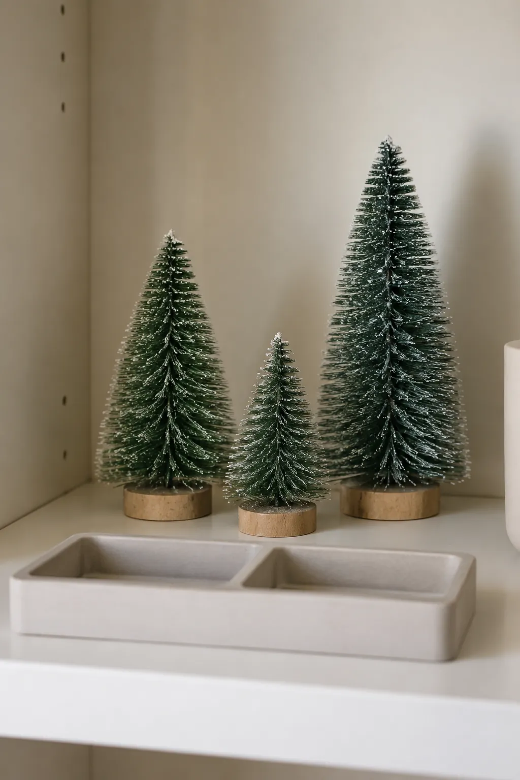 Miniature bottle brush trees in a small apartment Christmas display