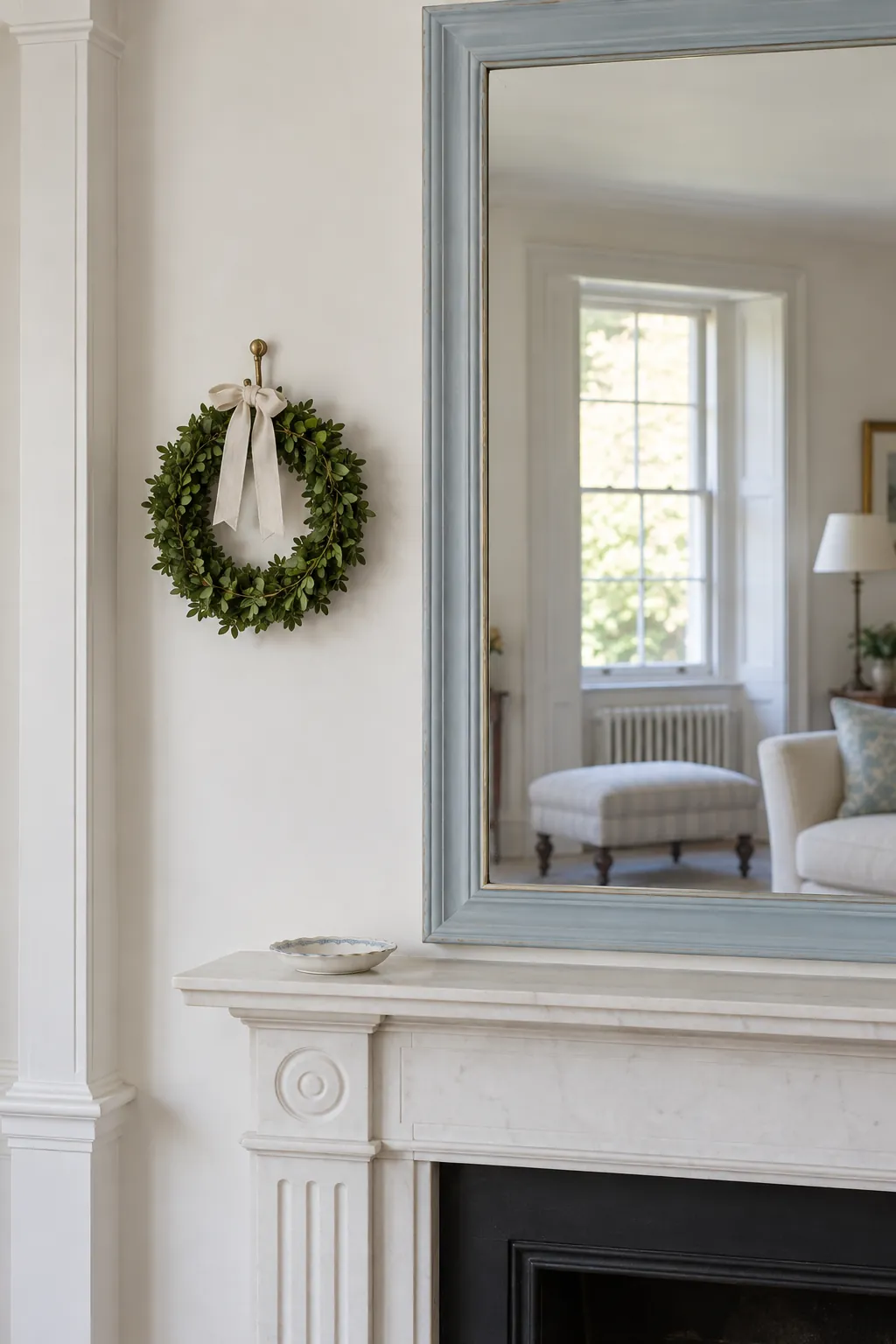A Small Wreath Beside the Mirror Christmas mantel arrangement beneath a large mirror