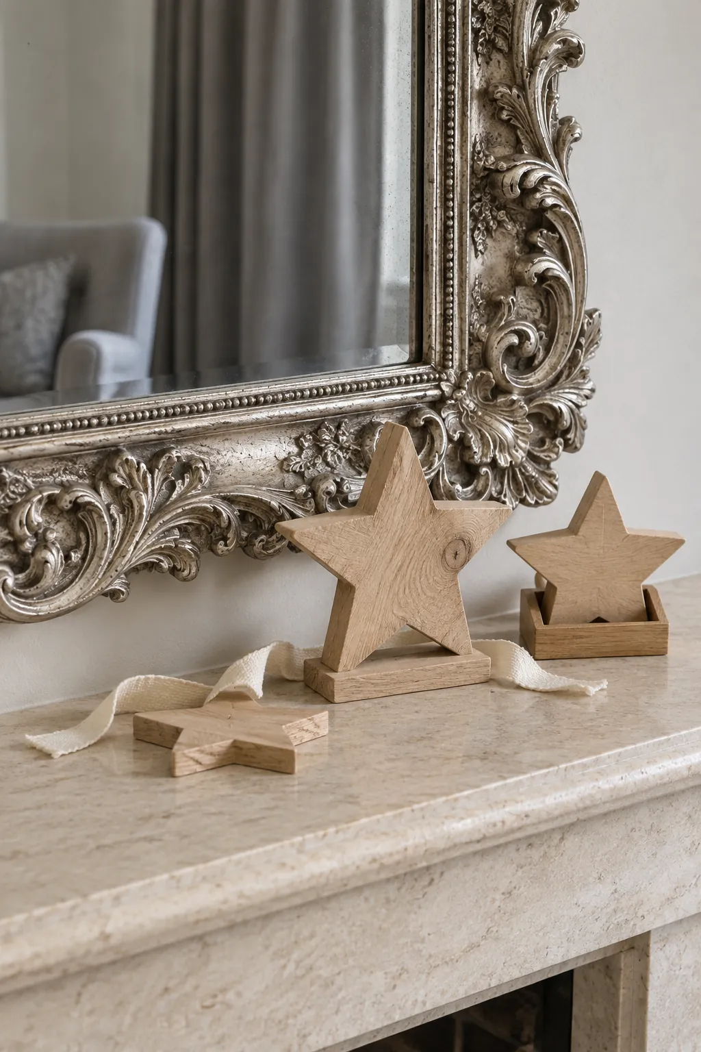 A Low Wooden Star Group Christmas mantel arrangement beneath a large mirror