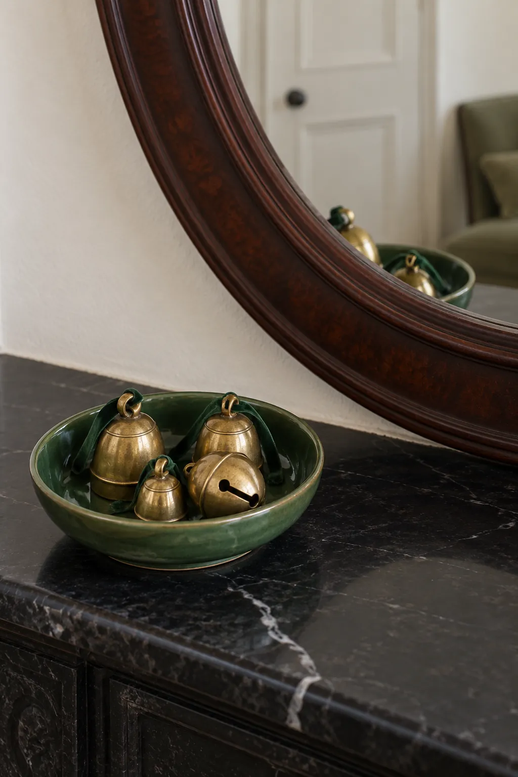 Tiny Bells in a Ceramic Dish Christmas mantel arrangement beneath a large mirror