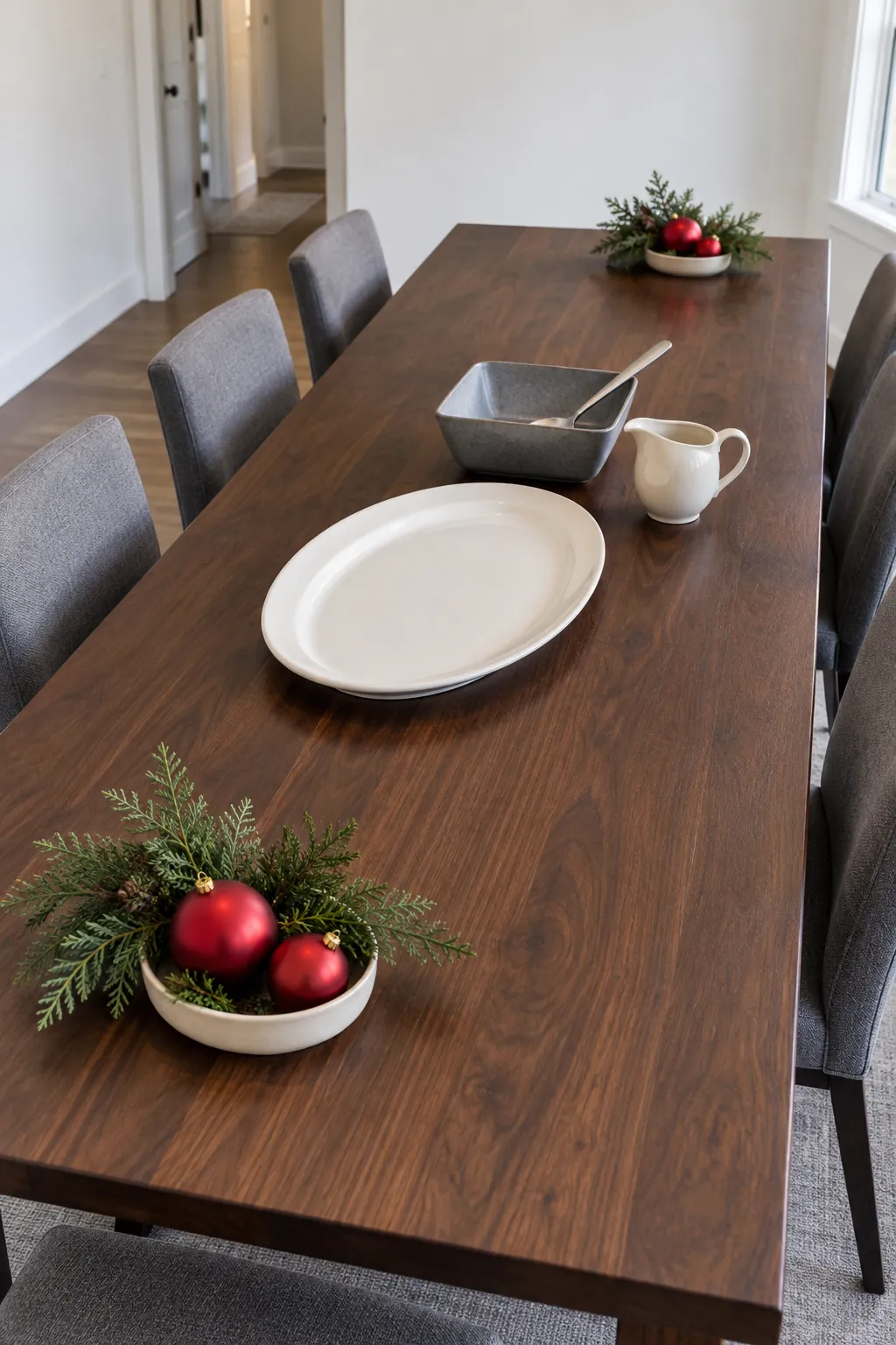 Low holiday decoration groups at free table ends with the middle open for platters