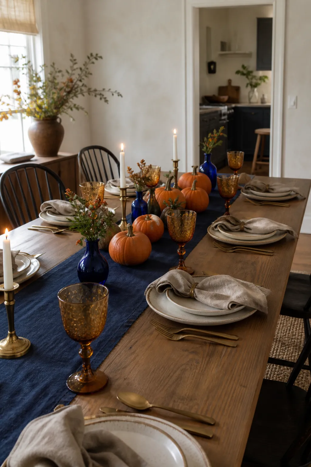 Blue and orange fall table decor with pumpkins and elegant place settings