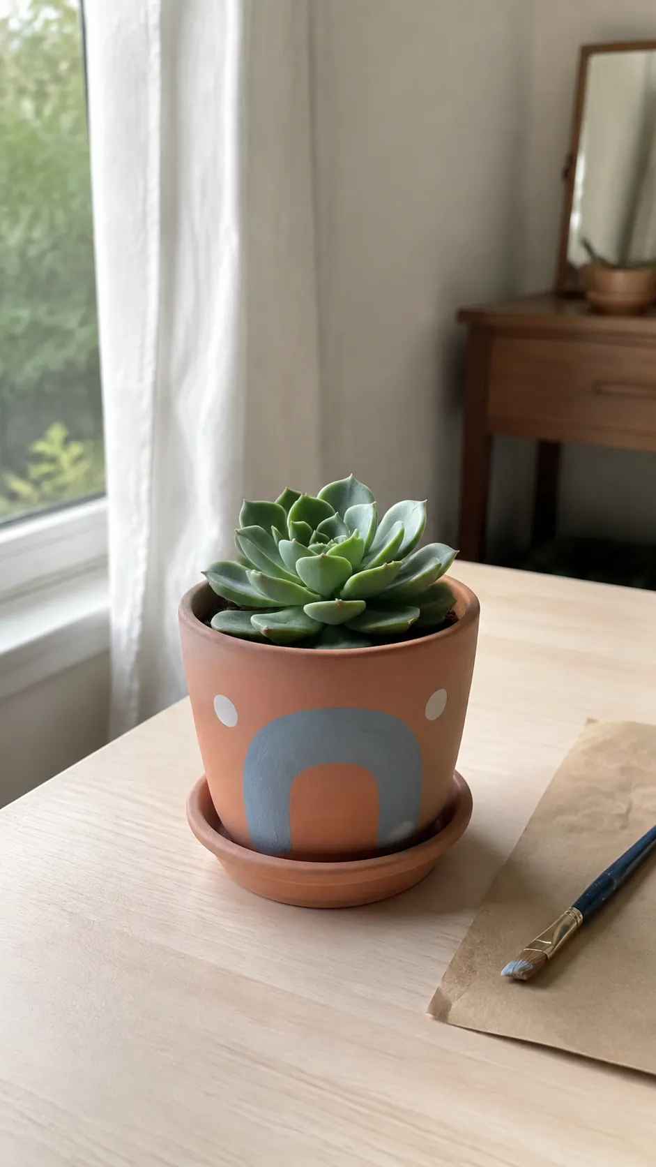 Hand painted succulent pot with a blue arch and white dots