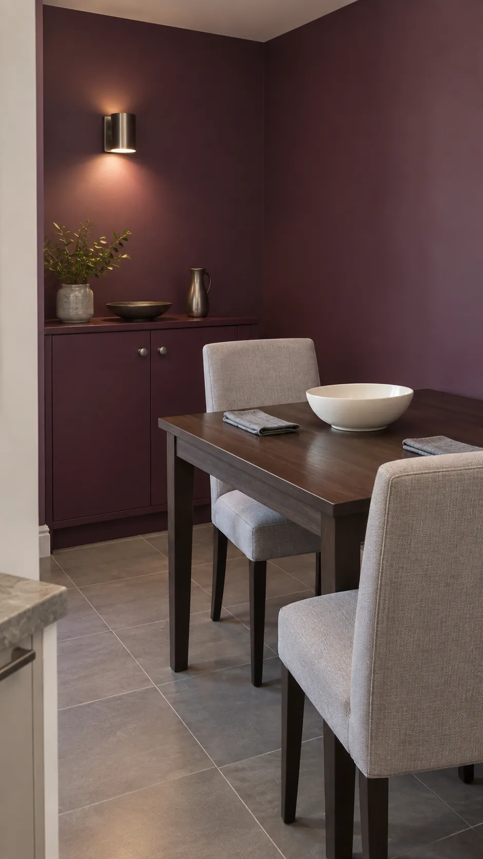 Plum dining alcove with pale gray upholstered chairs and pewter handles
