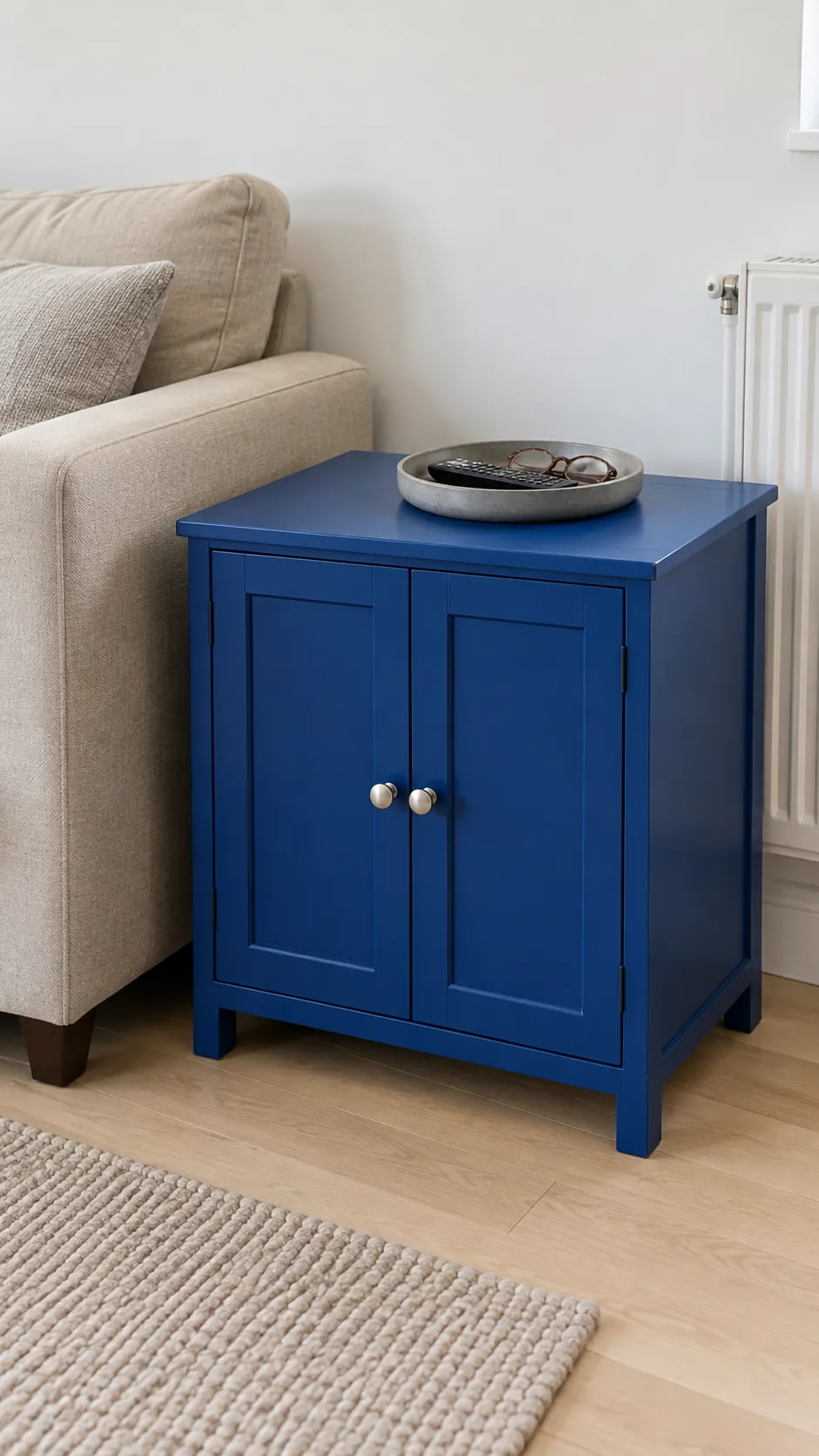 Small cobalt blue cabinet beside a beige living room sofa