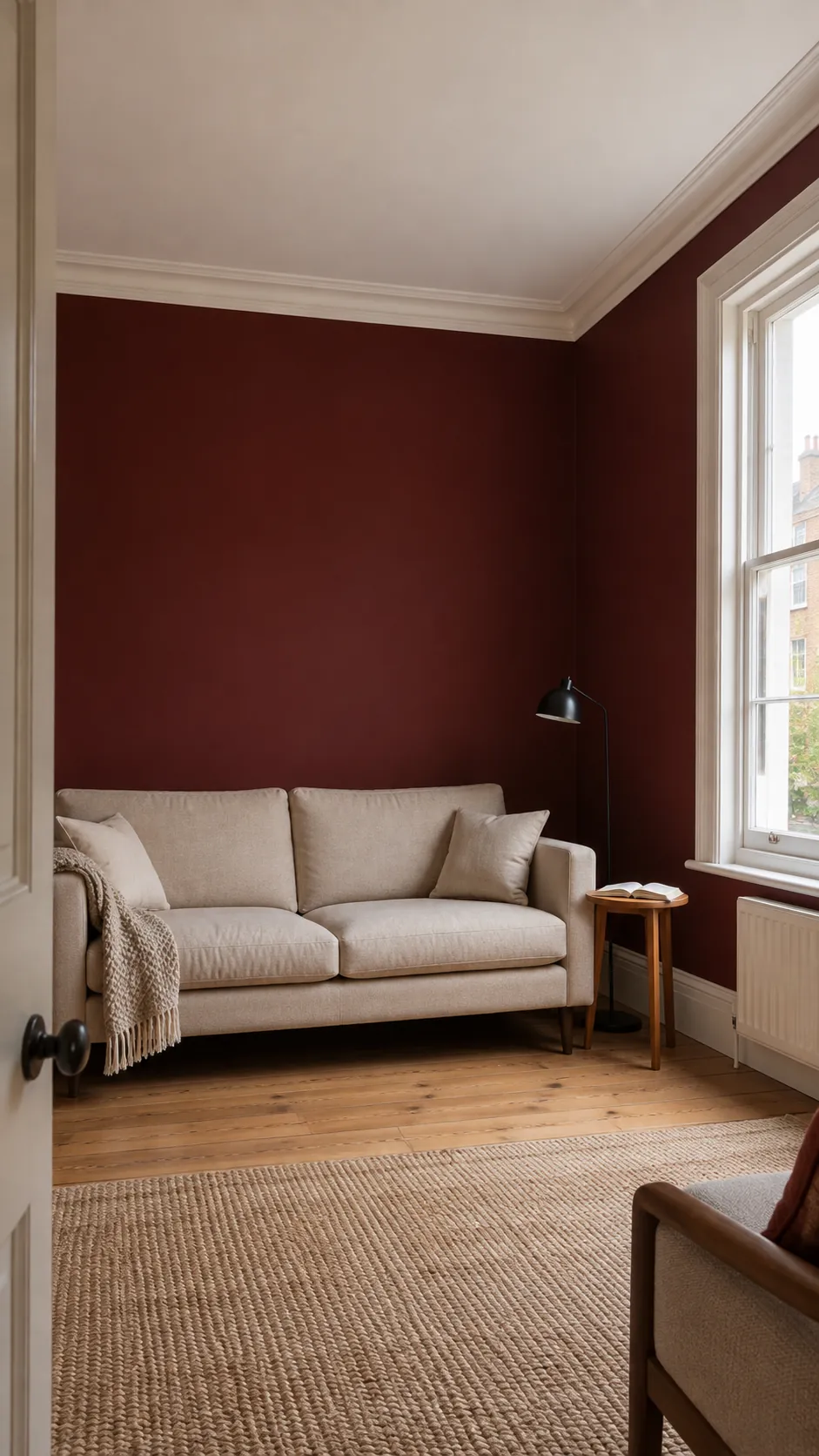 Pale ceiling and oatmeal sofa balancing burgundy living room walls