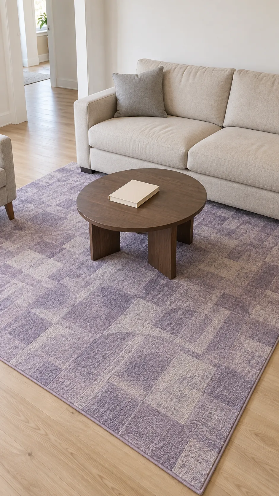 Dusty lavender rug beneath beige seating in a neutral living room