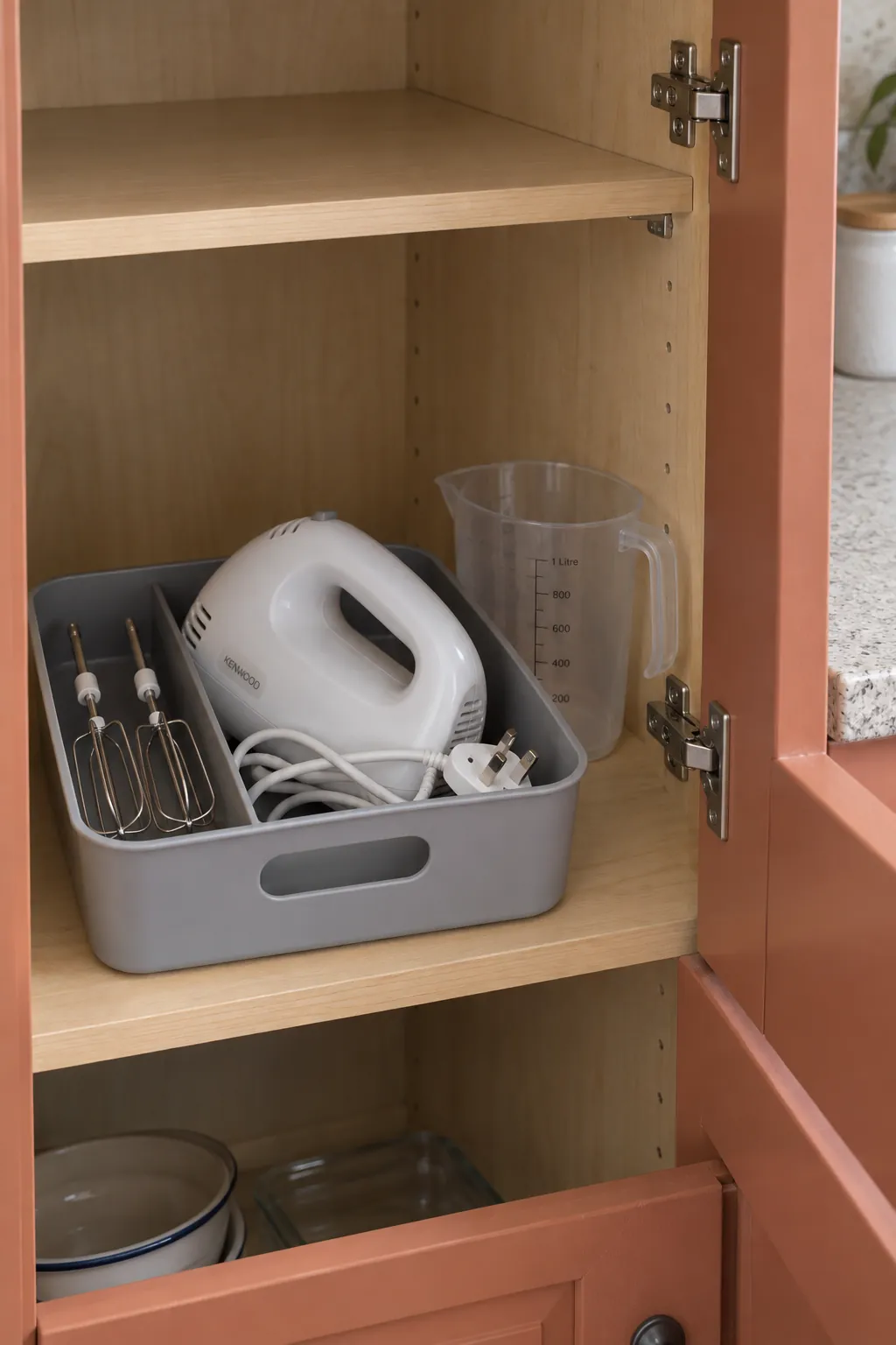 Hand mixer and attachments stored together off the countertop