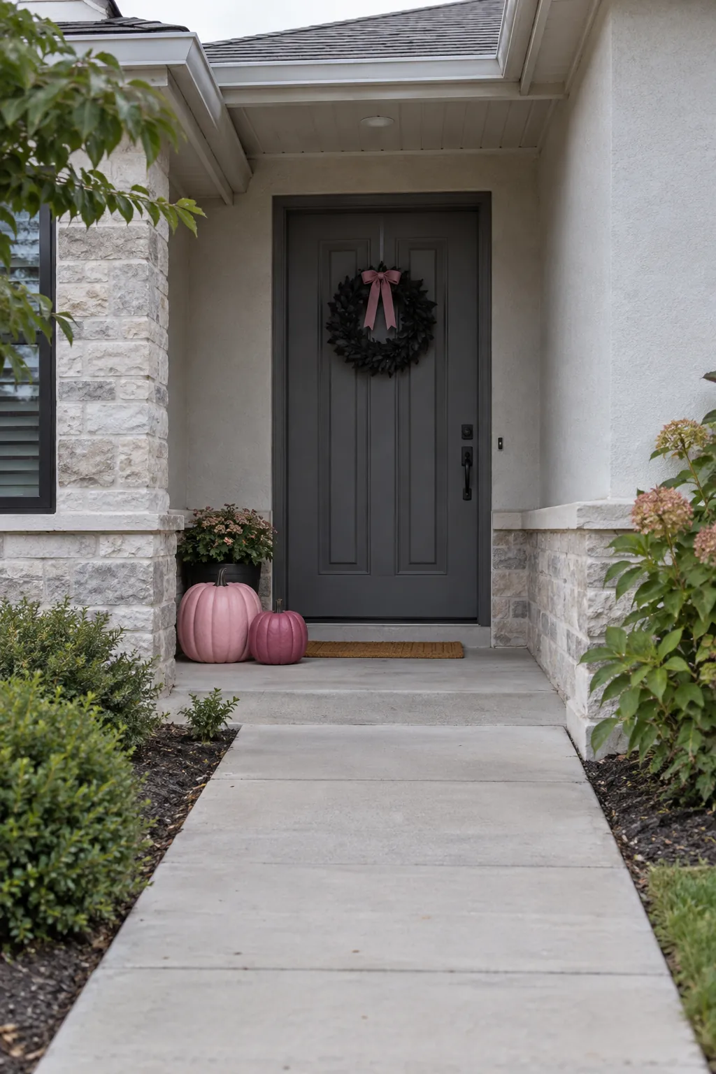 Sheltered entrance with pink Halloween pumpkins and a clear outdoor path