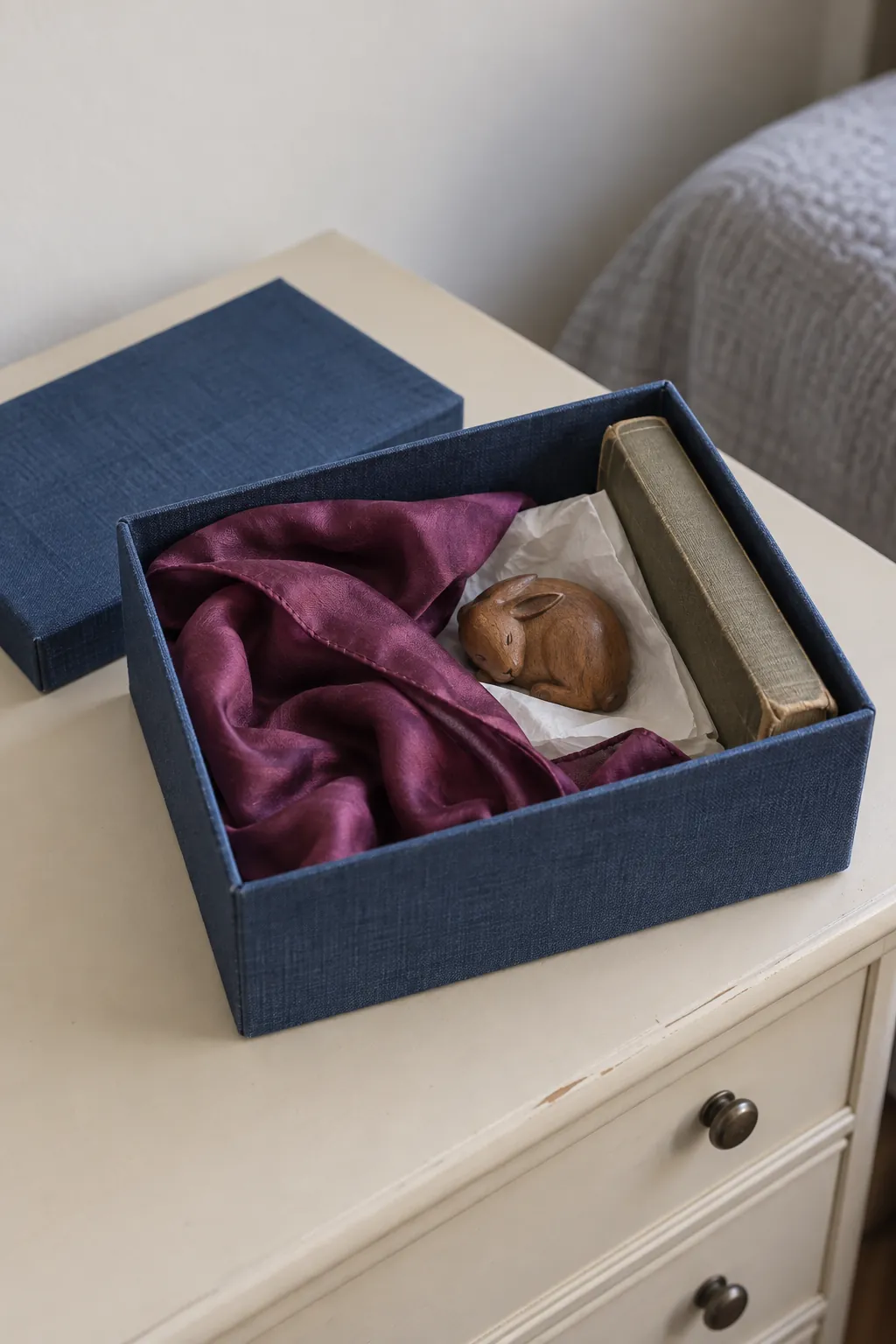 Small memory box holding a scarf and treasured keepsakes