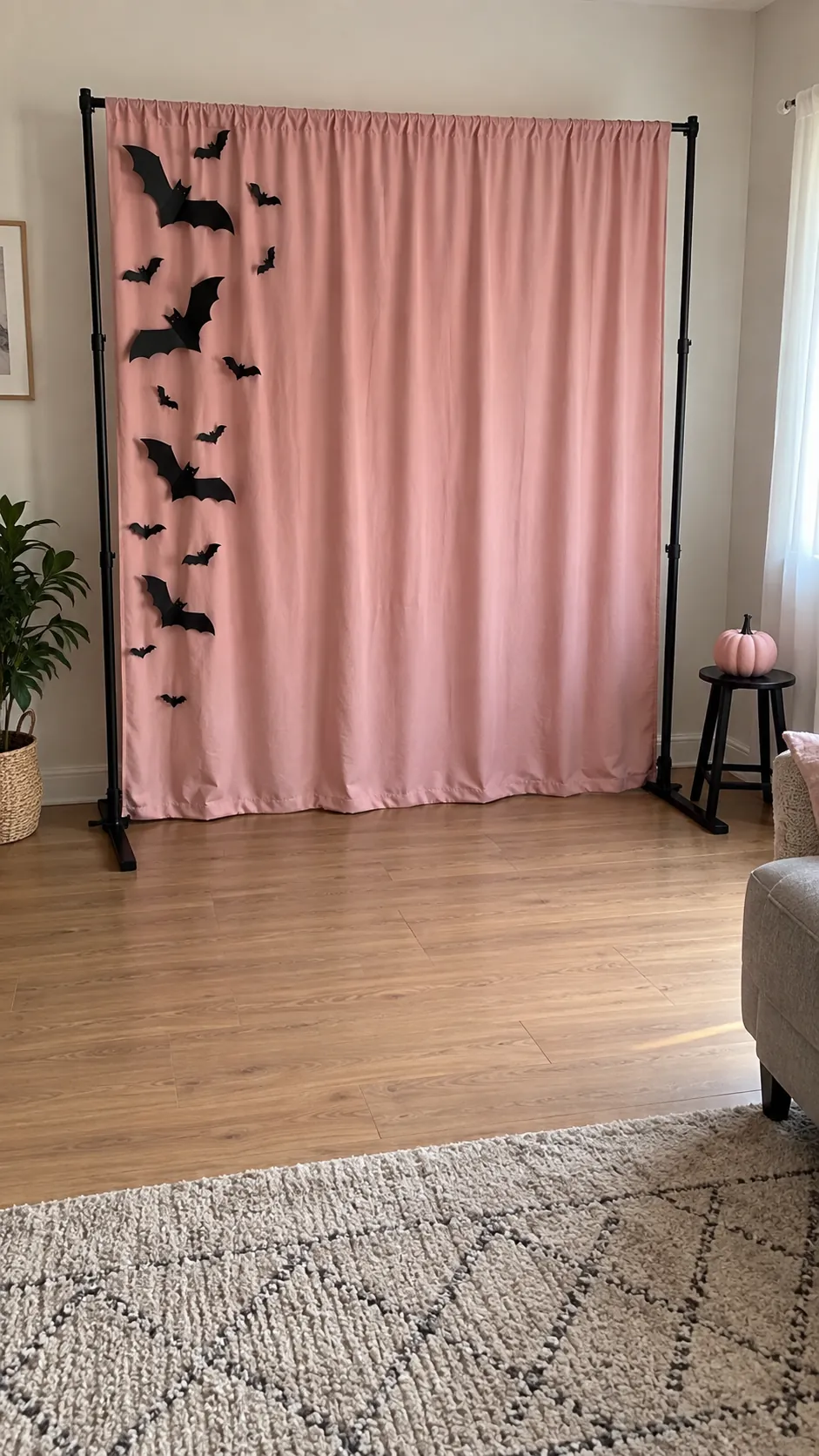 A small party photo corner in black and pink Halloween decor