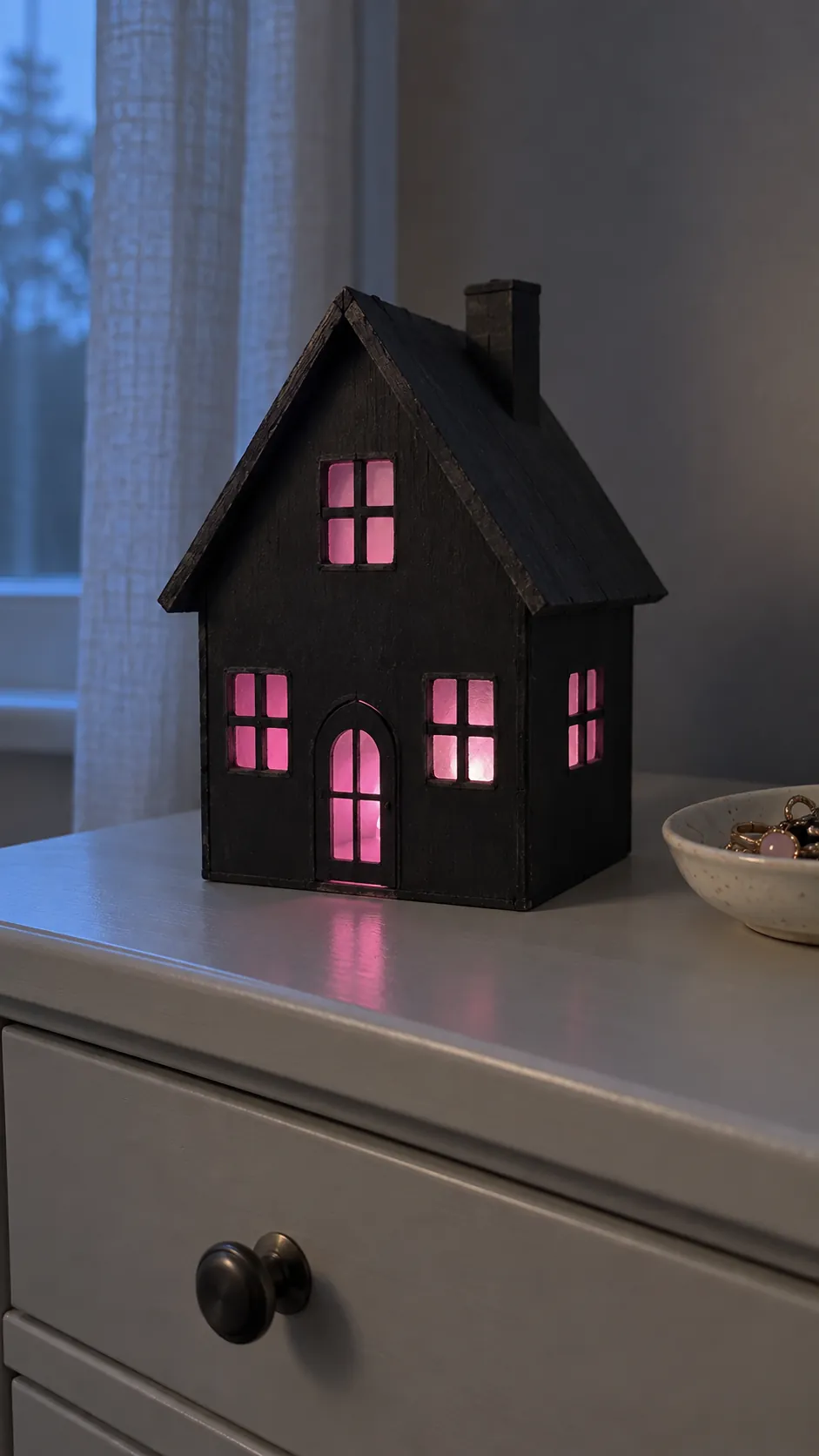 A tiny haunted house lantern in black and pink Halloween decor