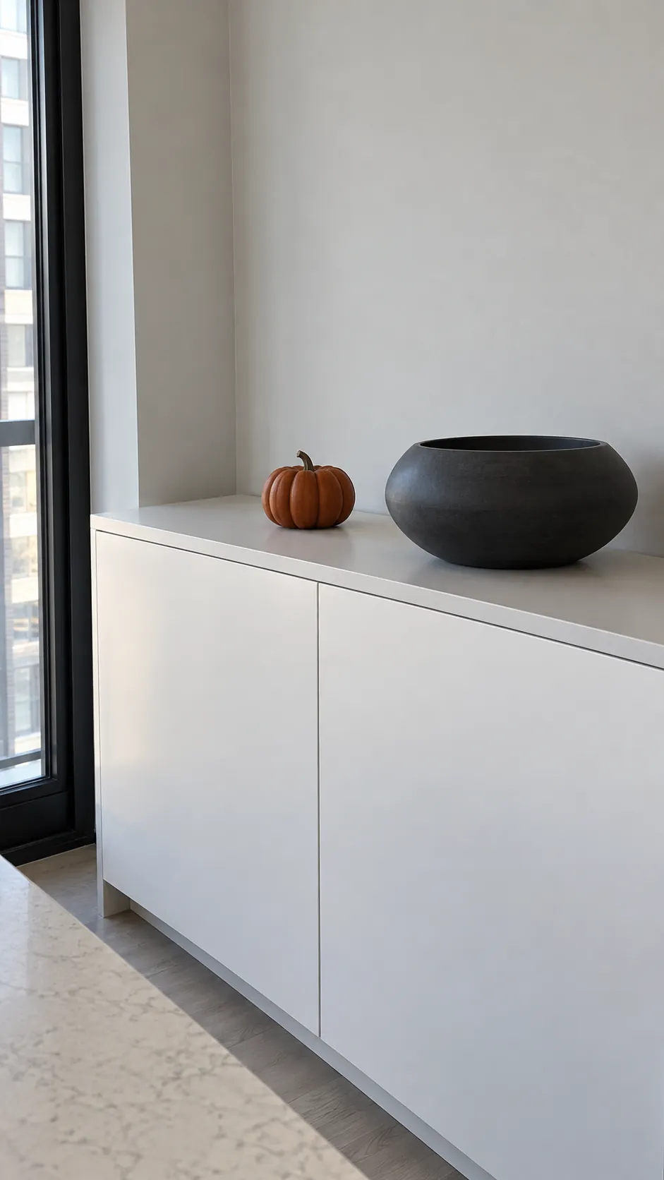 Use a single dark shape in a pale kitchen for fall decor on kitchen cabinets