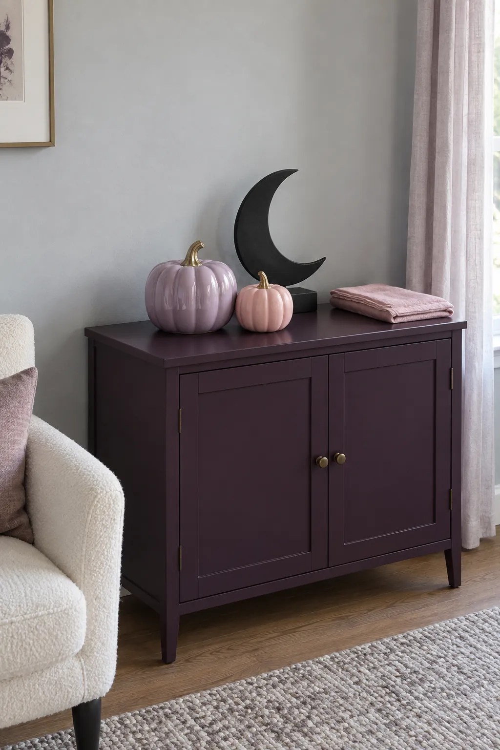 Lilac and pink Halloween pumpkins on a plum cabinet