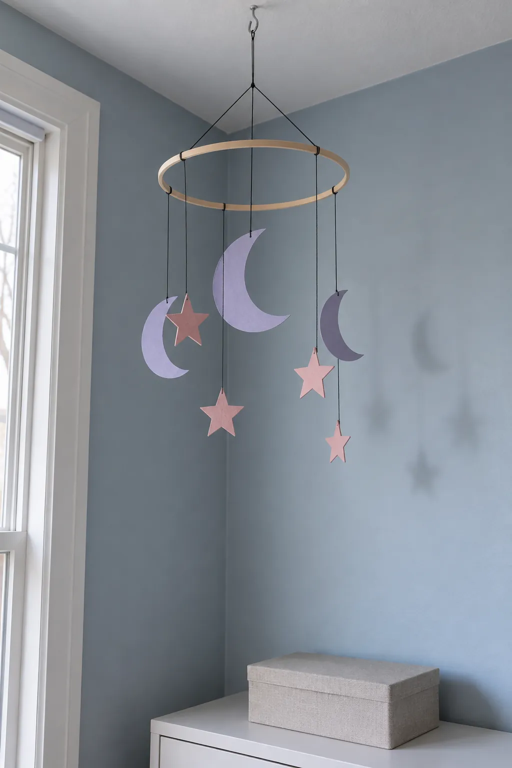 Let a paper moon mobile use the empty corner with purple and pink Halloween decor