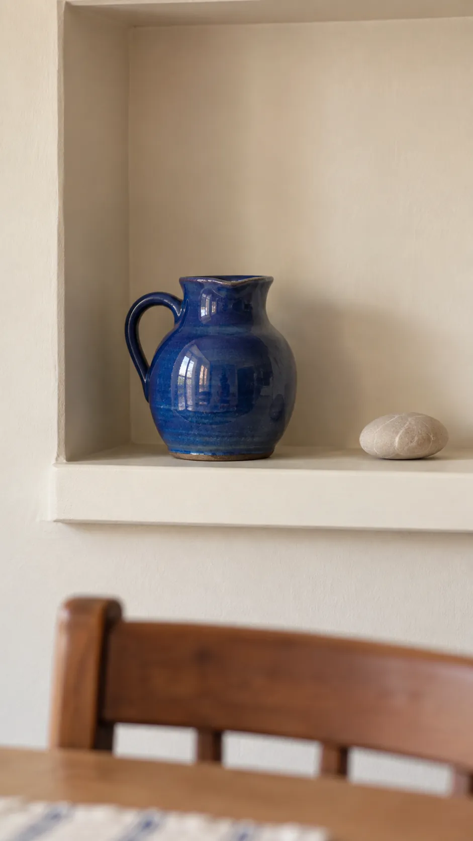A small shelf centered around one treasured ceramic piece