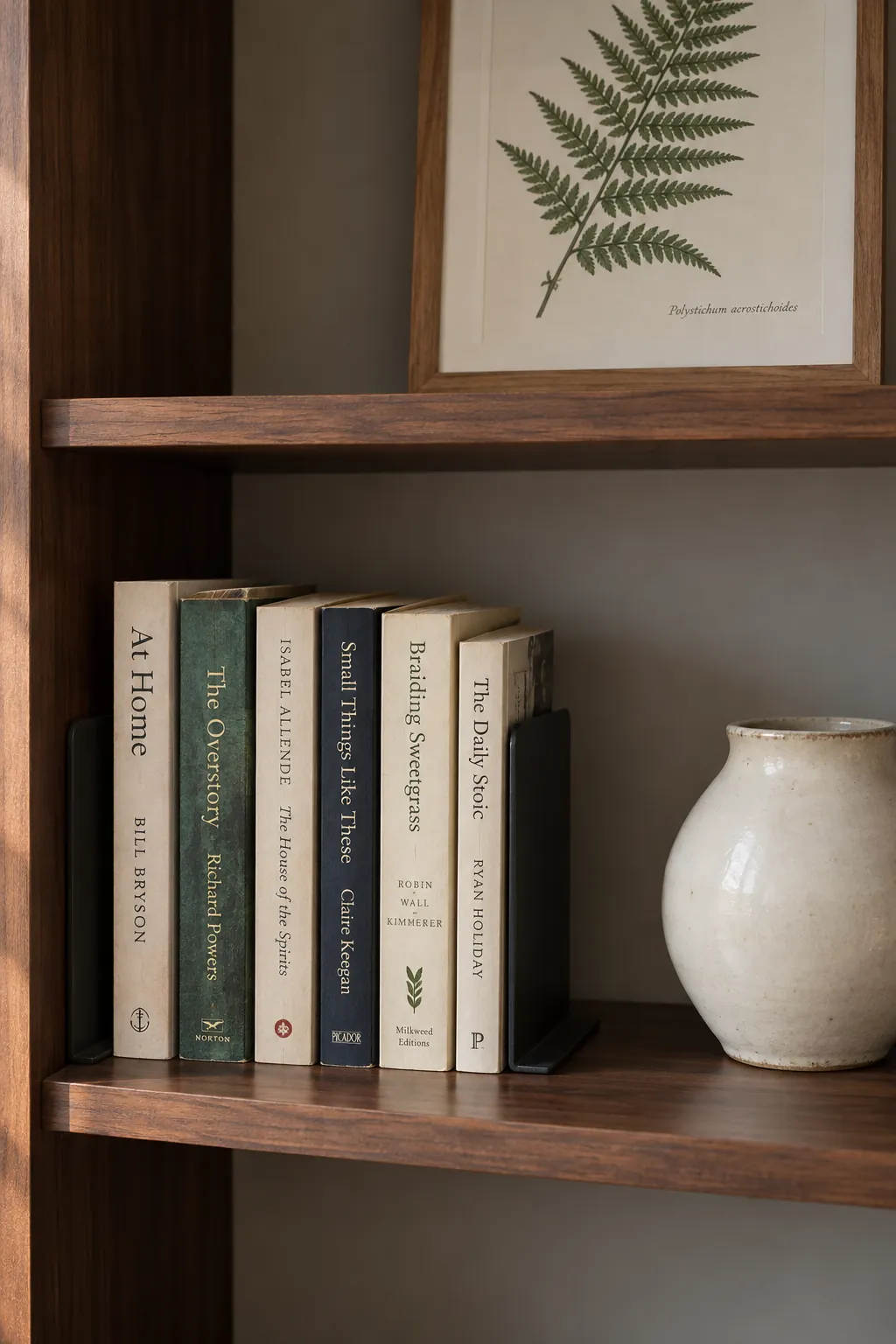Book grouping with a separate ceramic object and open shelf space