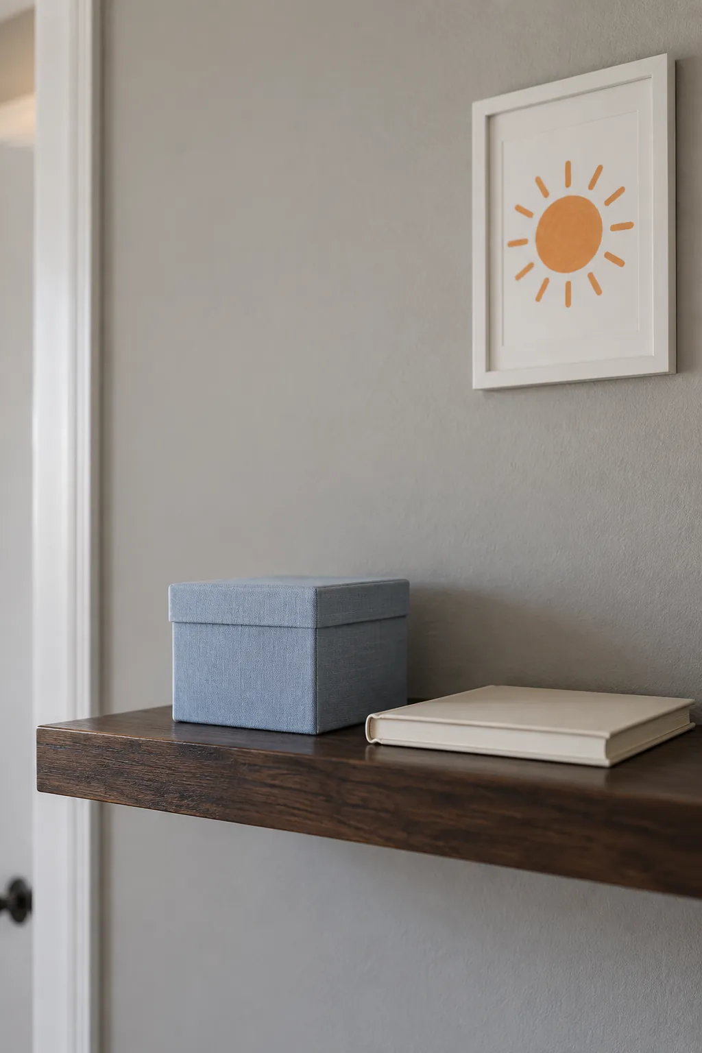 Simple fabric keepsake box on a nursery display shelf