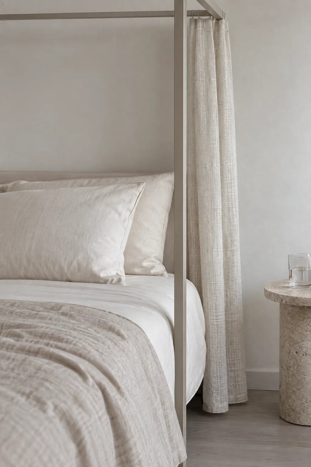A textured neutral canopy without extra ornaments in a practical canopy bedroom