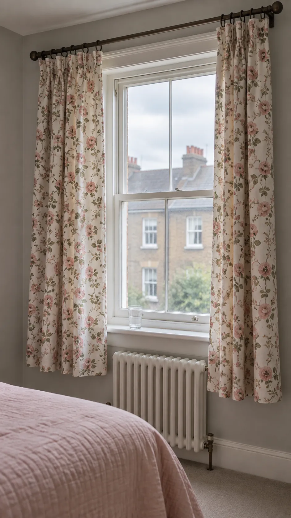 Small floral curtains beside a simple bedroom window